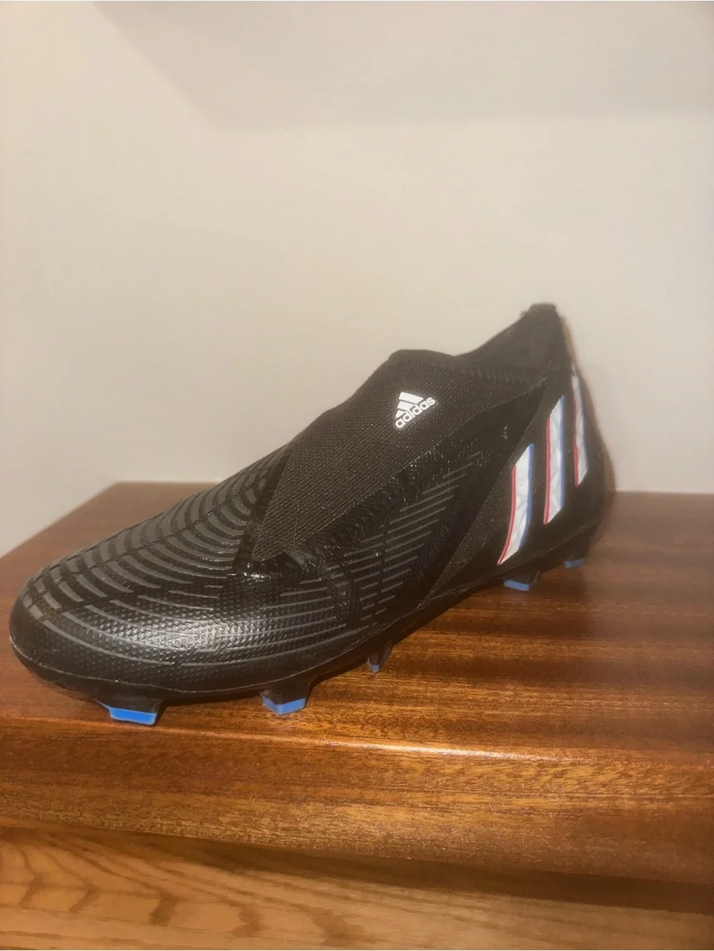 adidas Black Soccer Cleat with Blue and Red Stripe Accents